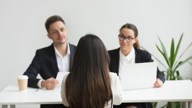 Headhunters interviewing female job candidate